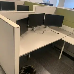 Used Global Evolve 6x6 sit-stand cubicle with green accent panels and pedestal storage