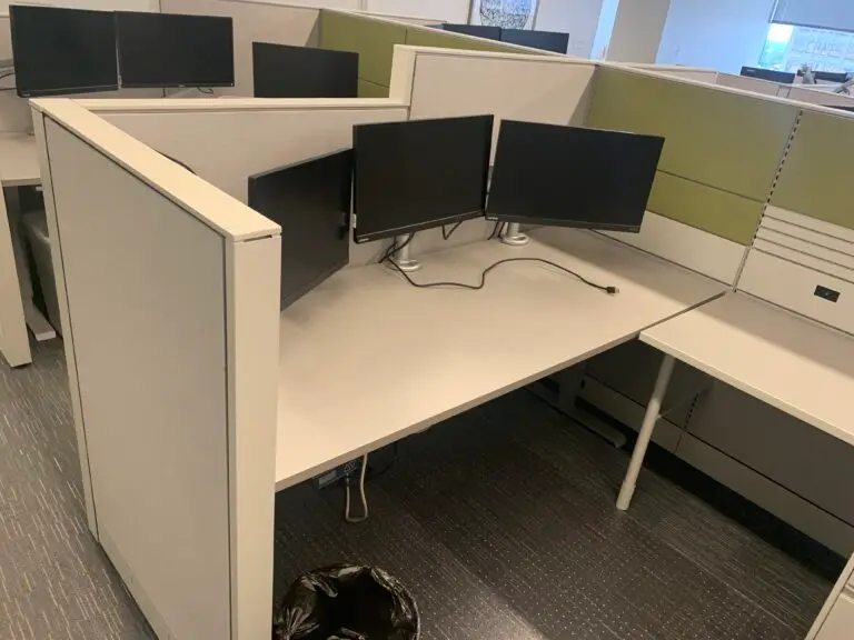 Global Evolve used cubicle with green accent panels and a sit-stand desk