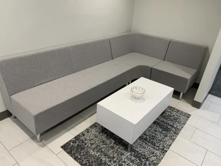 Pre-owned Global gray lobby seating arranged with a white coffee table